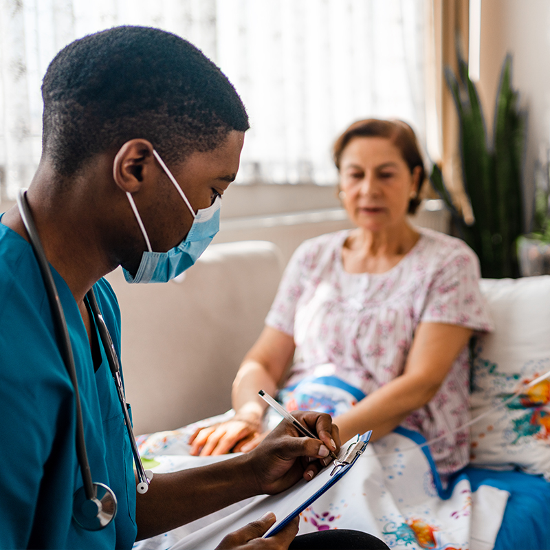 Male nurse giving chemo to patient